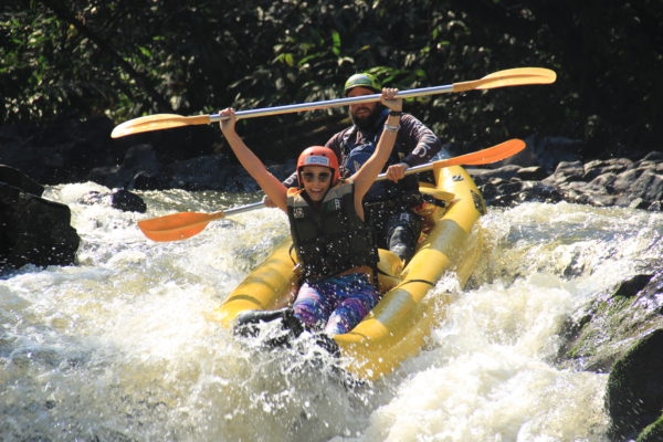 Duck radical é um barco estreito para duas pessoas, uma em frente a outra descendo uma queda d'agua